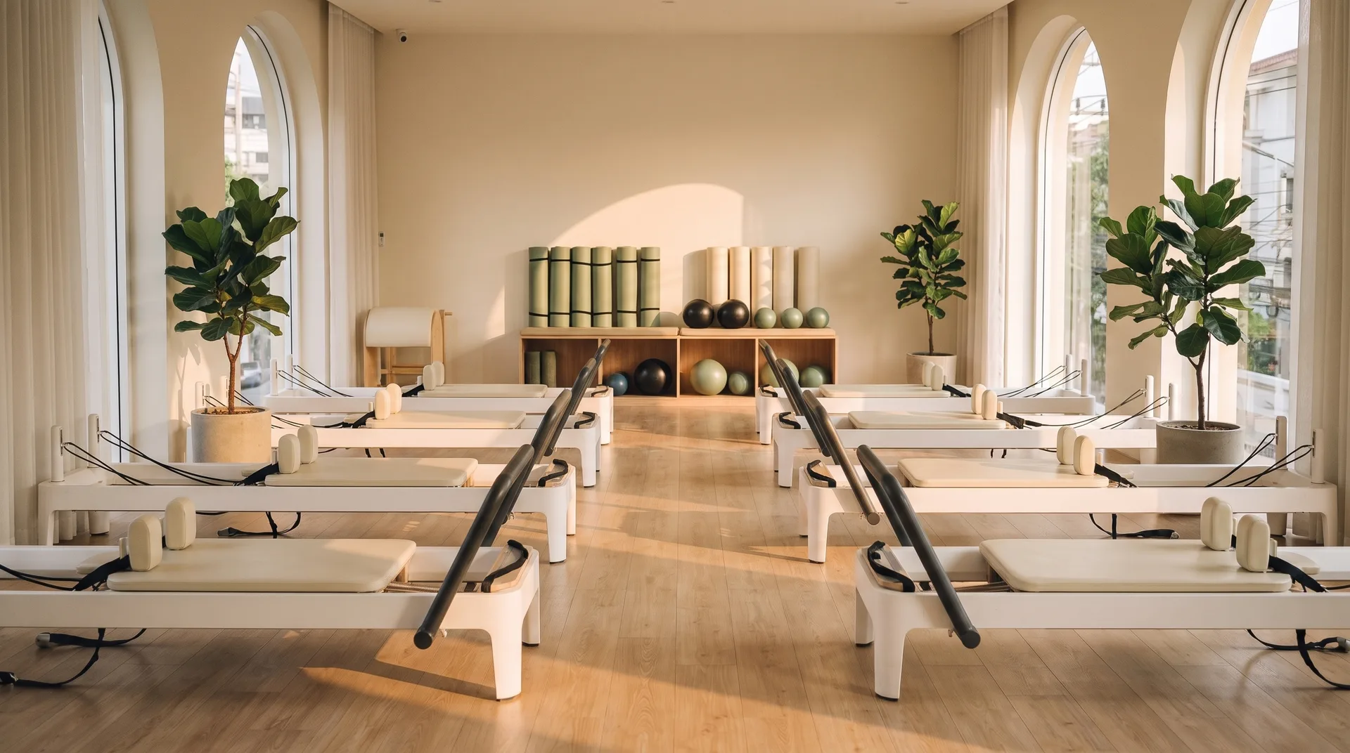 An empty boutique reformer studio in warm evening light